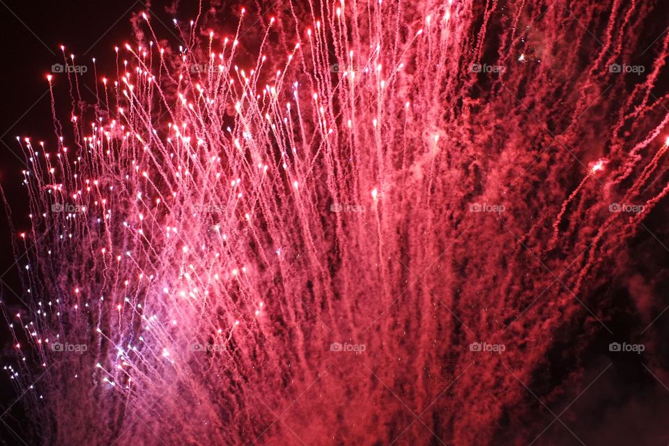 Fire red fireworks explode into the night sky at the Royal show