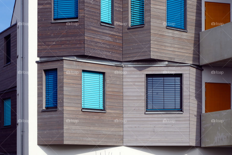 Close-up of building exterior with windows at day.