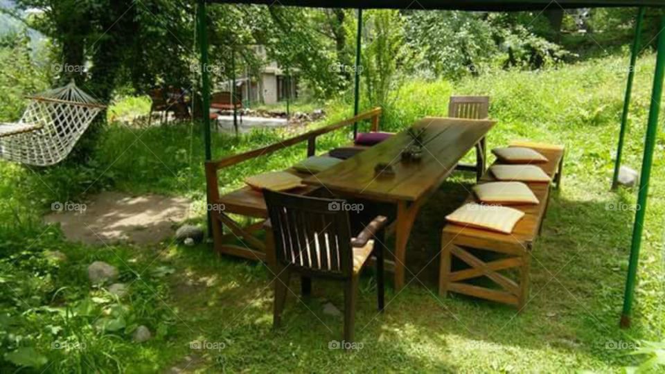 green velly of upper himachal pradesh. relaxing time, green grass, beautiful place to visit, outdoor dinning table, with sun rays falling on it, summer time