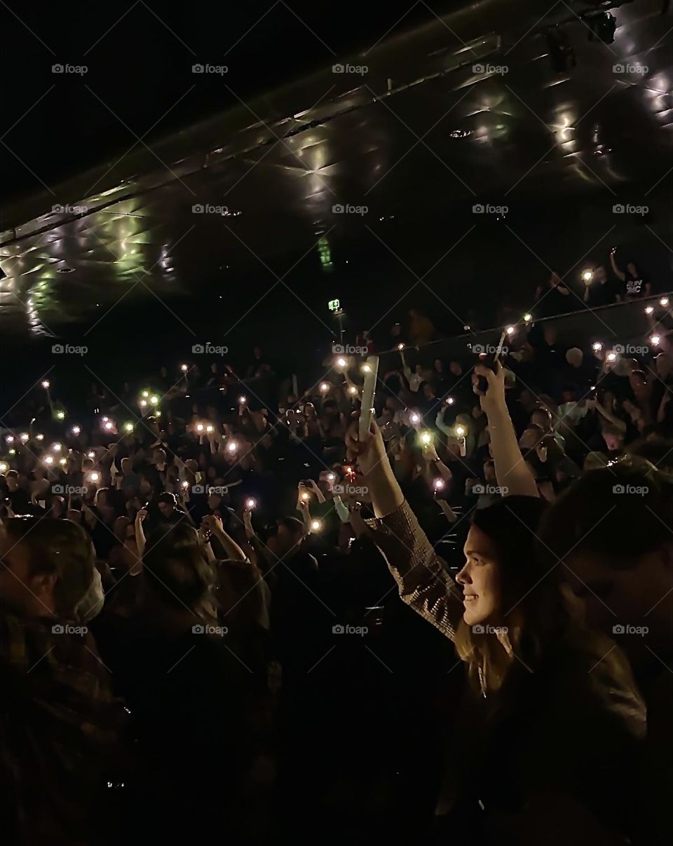 Holding up your flashlight during a concert
