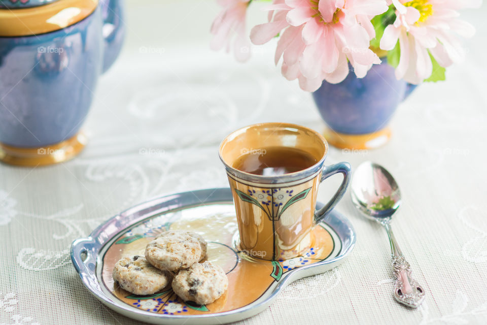 Cup of a green tea with cookies