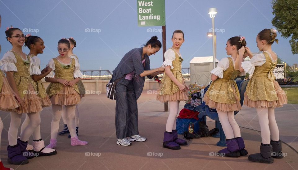 School girls get ready for an outdoor ballet performance.