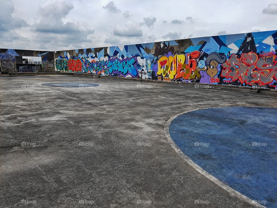empty space, abandonned building with mural art paint drawing colorful graffiti