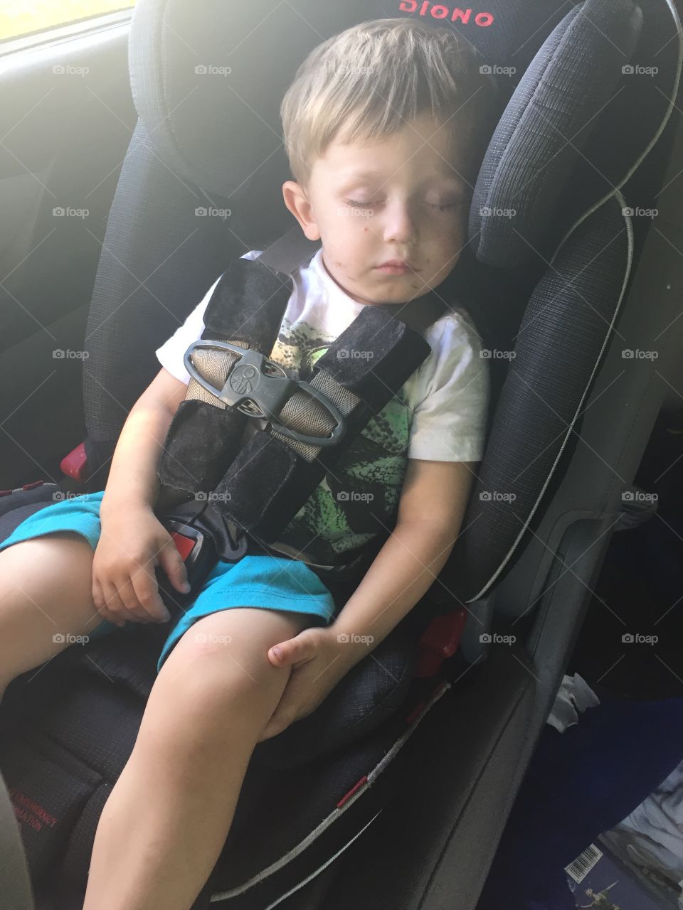 Small boy sleeping in car