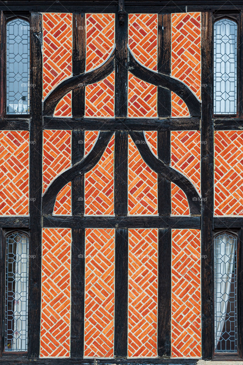 Exemplar of black intricate timber framed Tudor brickwork architecture. Well preserved from 16th century. UK.