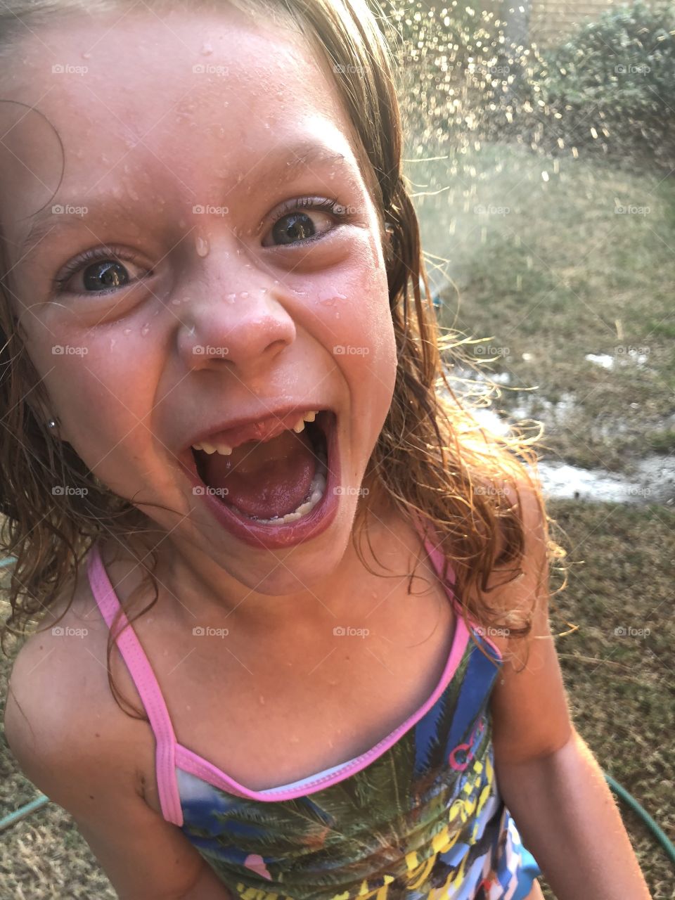 Girl enjoying sprinkler