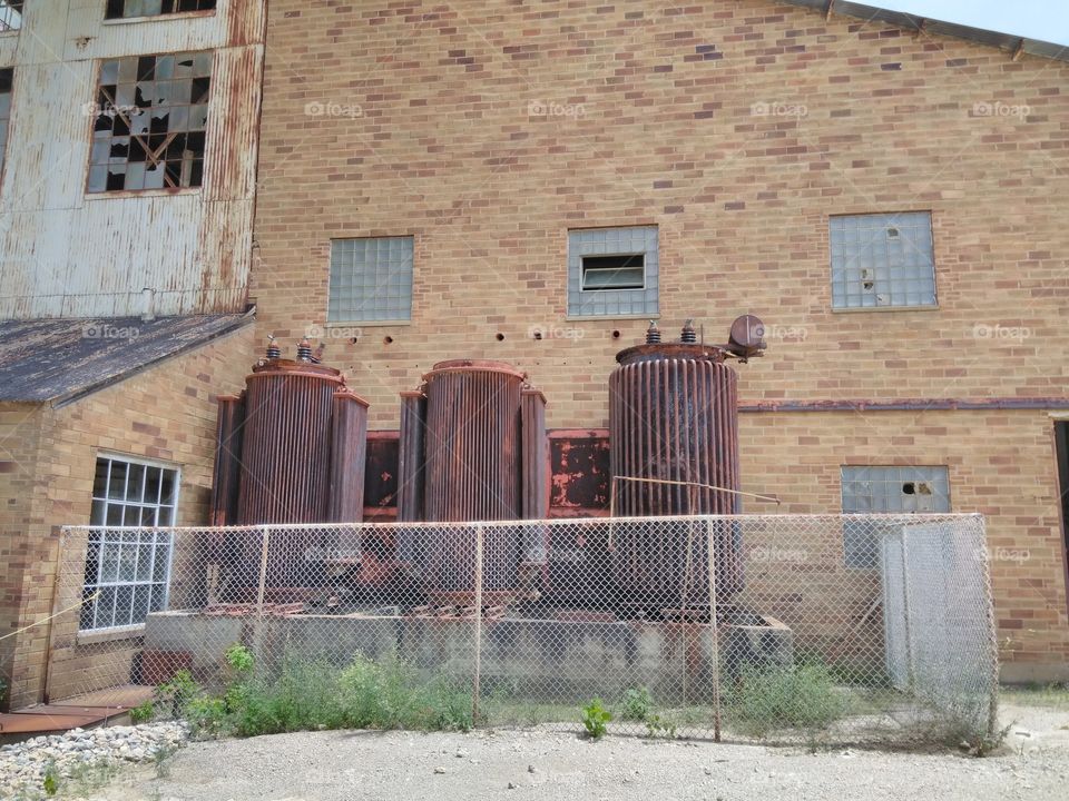 a trio of rusty cylinderical towers, the three musketeers