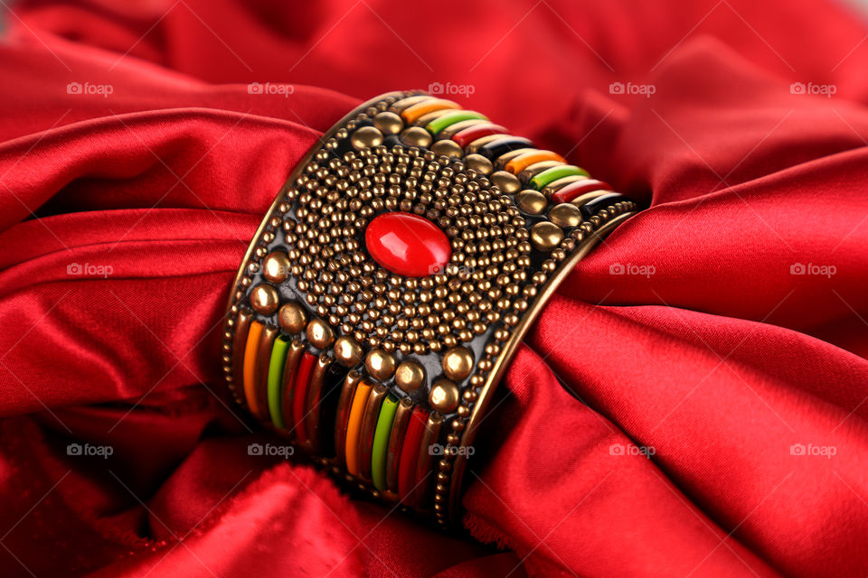 bracelet or bangle on red satin