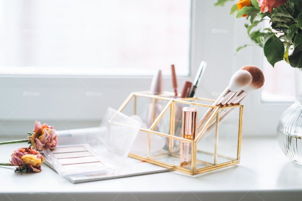 Makeup products on window sill