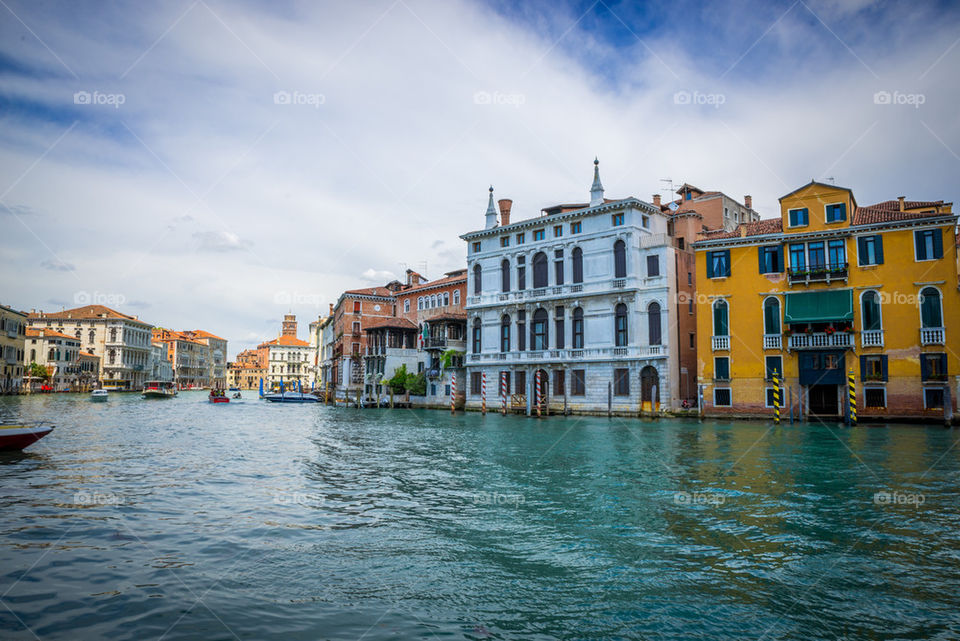 View of colored houses by canal in Venice