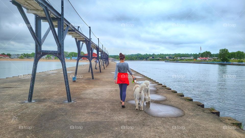 walking the dog on a pier at lake Michigan