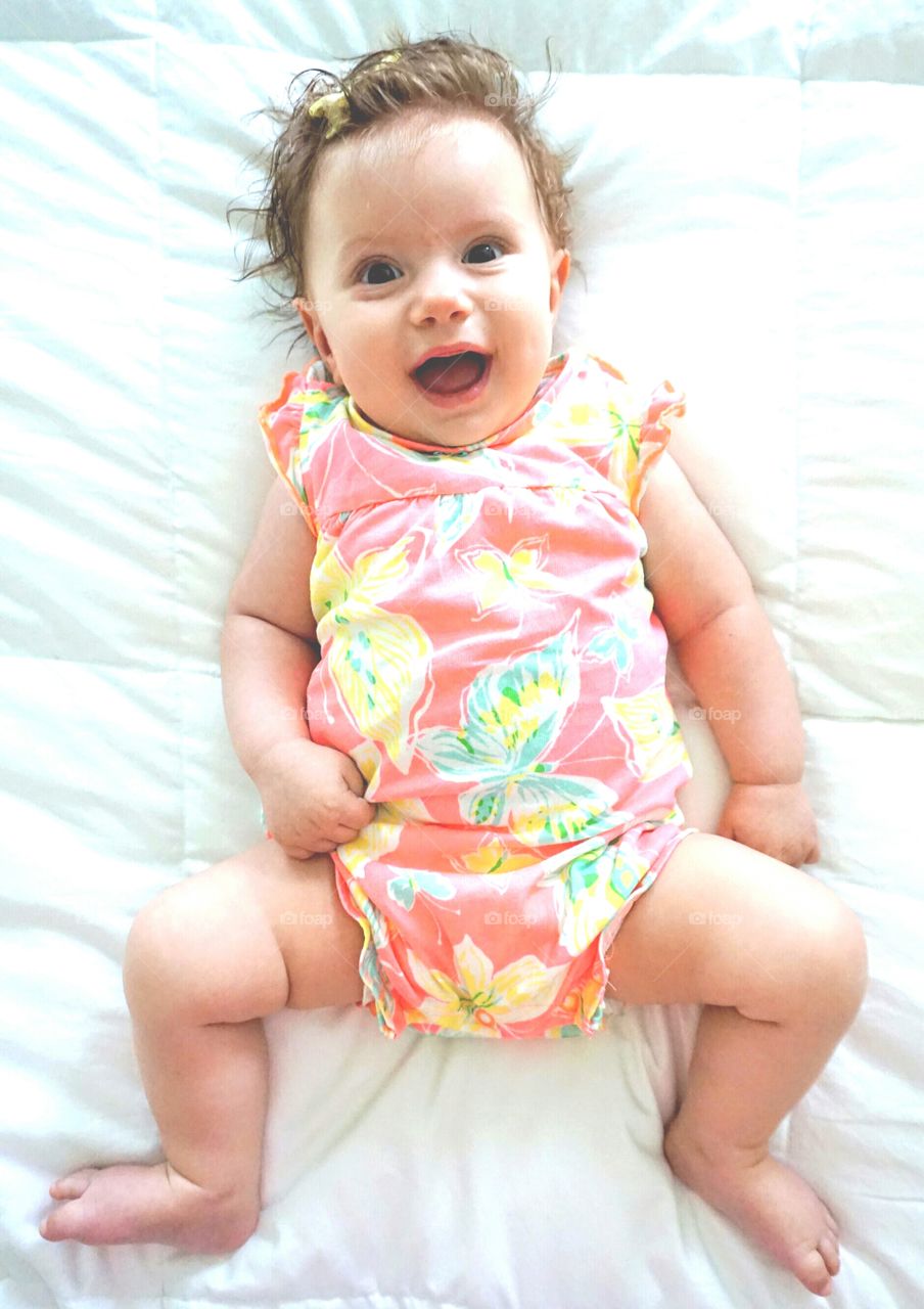 High angle view of baby lying on the bed