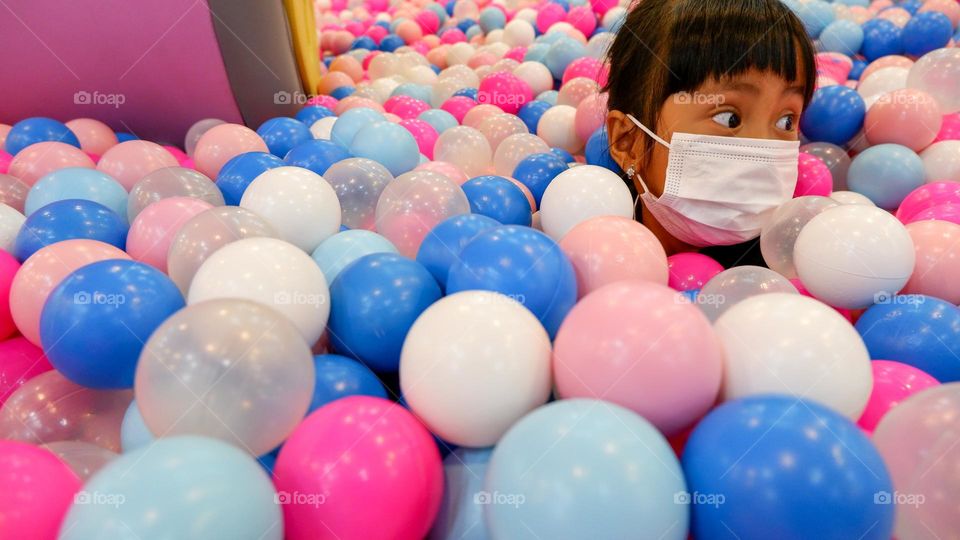 Play in a pool filled with colorful balls at the indoor playground