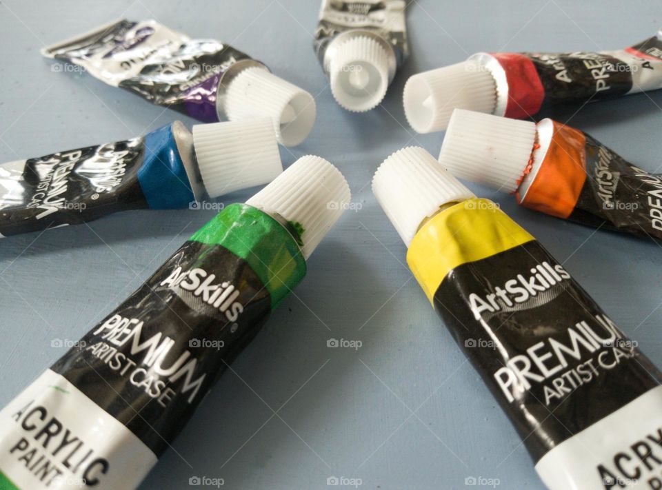 Rainbow paint tubes set up in a circle.