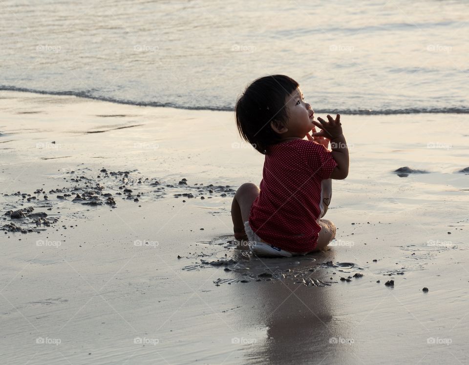 Kid enjoy her first time on the beach until sunset