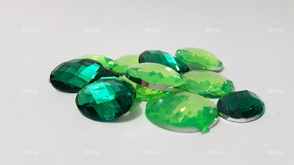 Emerald gemstone over white background