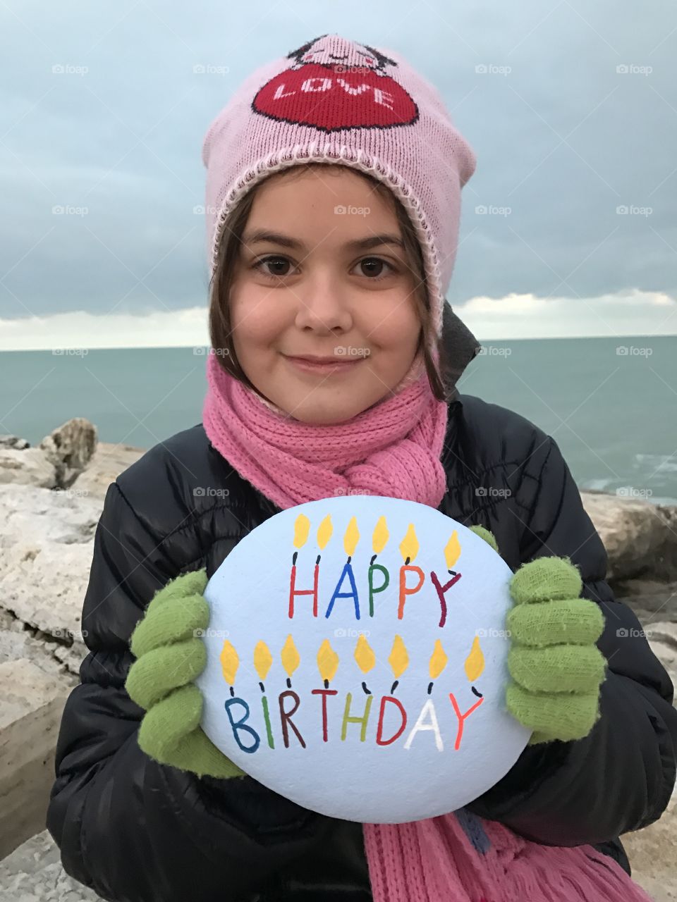 Portrait child holding text in hand