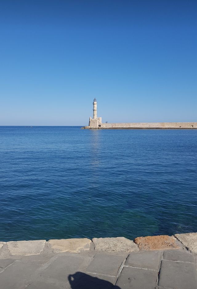 Summer fun, lighthouse in Crete, beautiful blue sky and ocean
