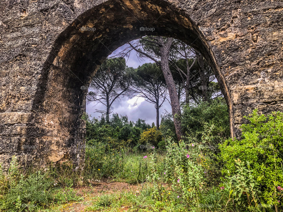 A view underneath one arch of the 6 kilometre aqueduct of the Convento de Cristo built 1593-1614, Tomar, Portugal 2021