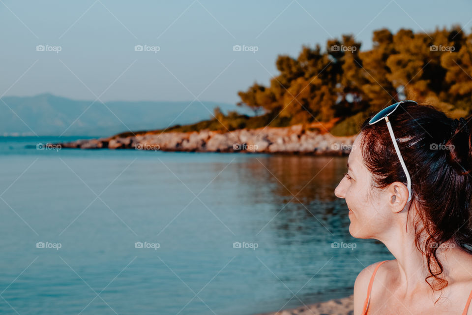 One young woman looking at the seascape.