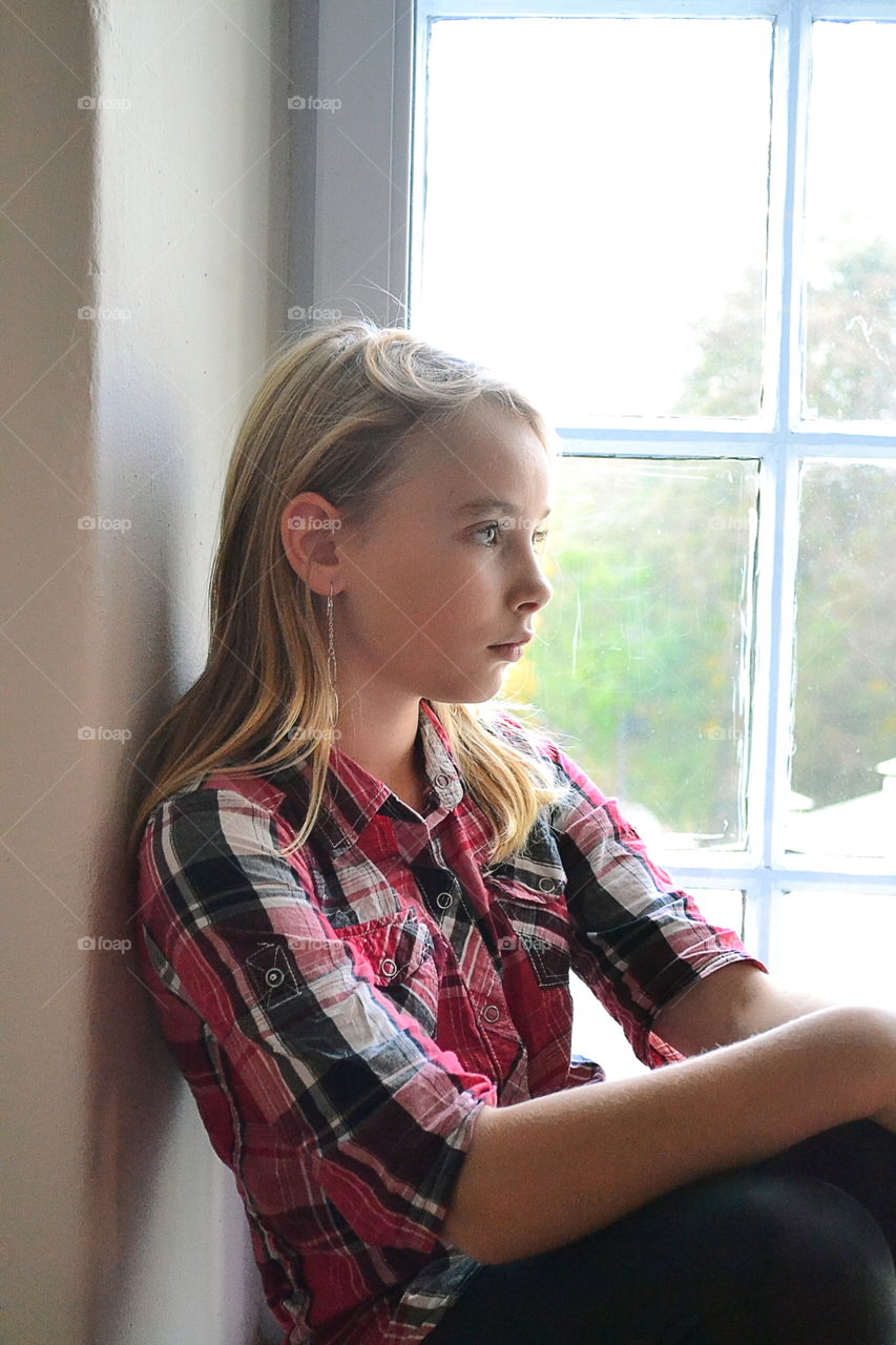 Girl sitting in the window