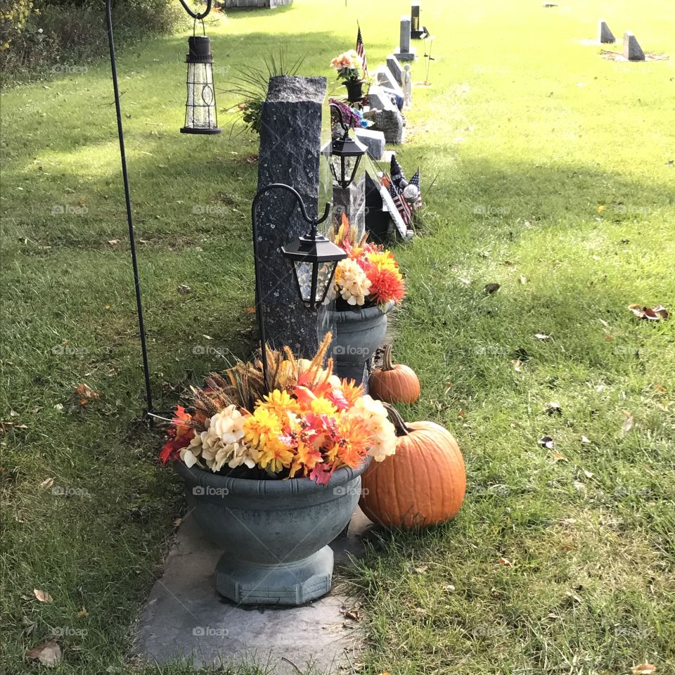 Looking down a row of tombstones at a cemetery.