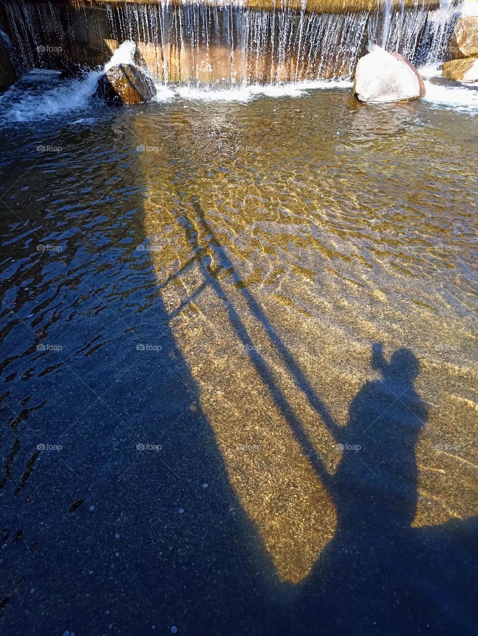 sunlight and shadows person on a waterfall beautiful texture abstract background