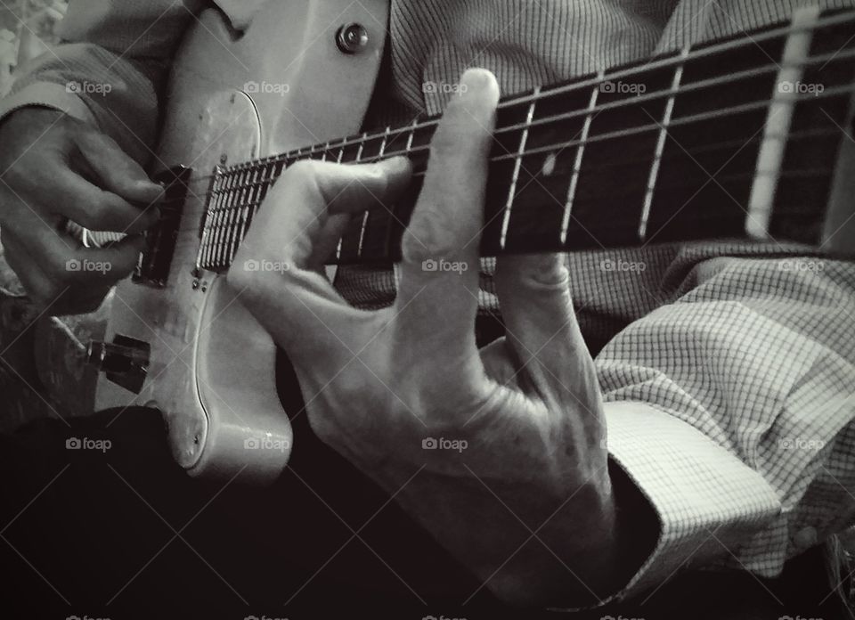 Man's Hands Playing Telecaster Style Guitar in Black and White