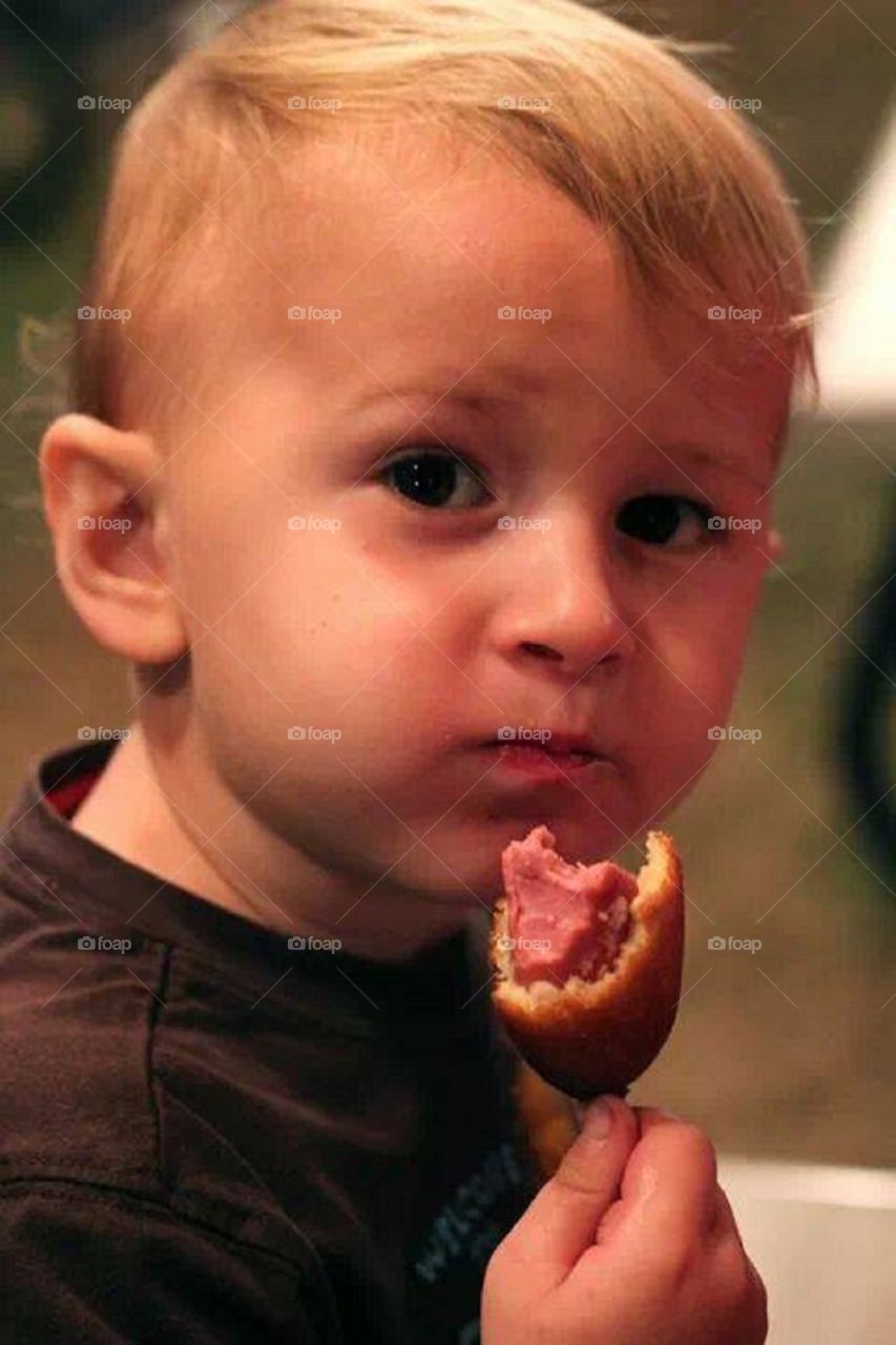 Jack and his corn dog. My nephew enjoys corn dog while at the county fair