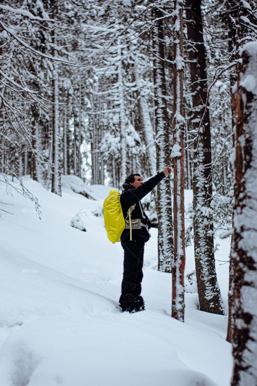 man taking a break just to admire the beautiful scenery in the forest