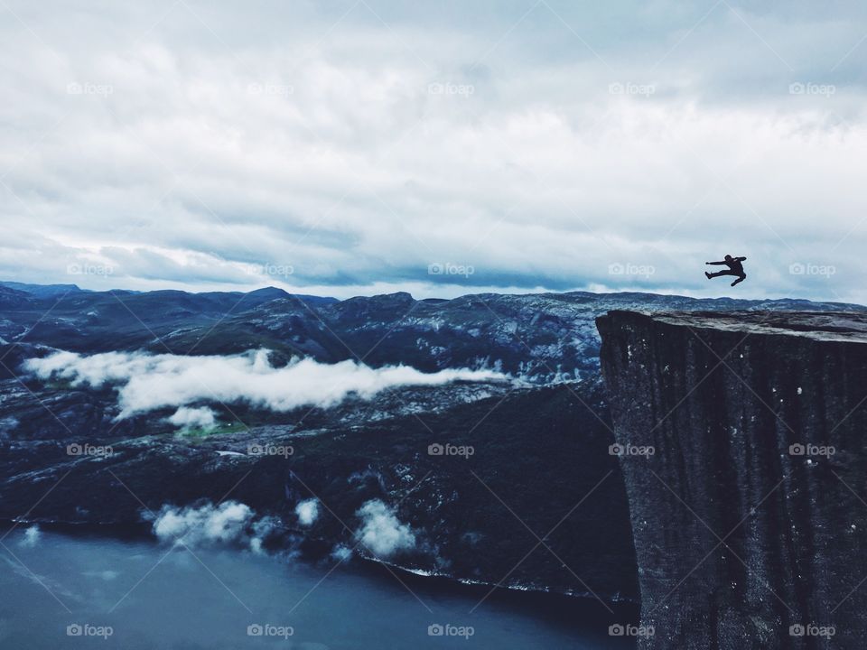 Solitude of person jumping on rock