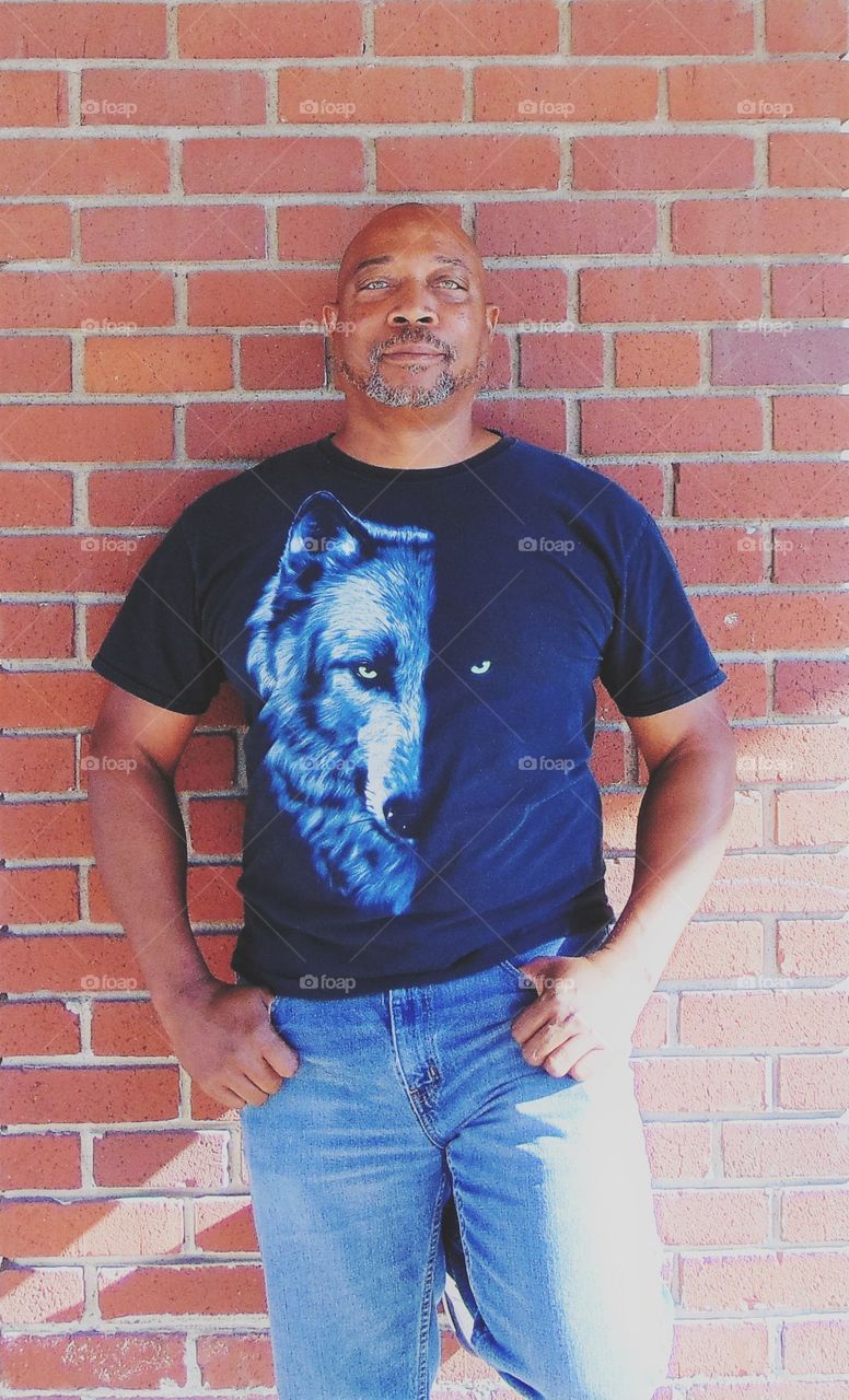 man modeling with red brick background