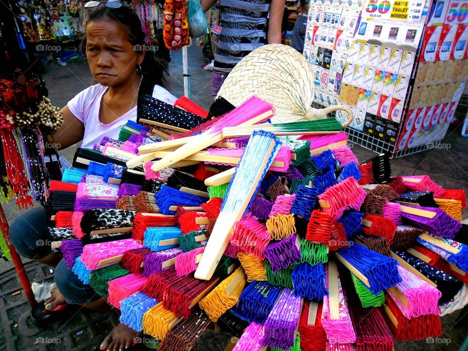 asian street vendor selling coloful fans in quiapo, manila, philippines in asia