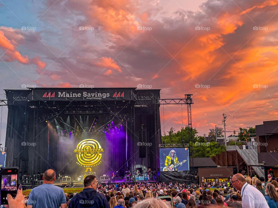 “The Sound of Sunset.”  Pastel colored clouds drift over a concert stage during sunset.