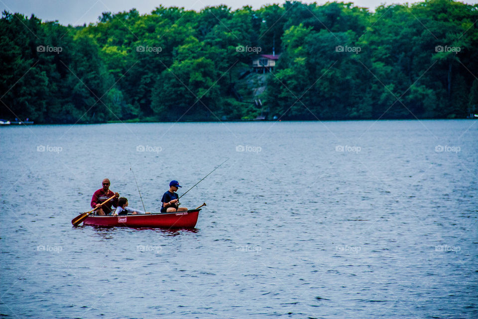 A boy and his grandfather, fishing on the lake