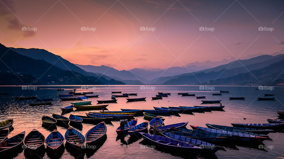 This Gloomy sunset and parking boats photo was taken during Pokhara tour, Nepal