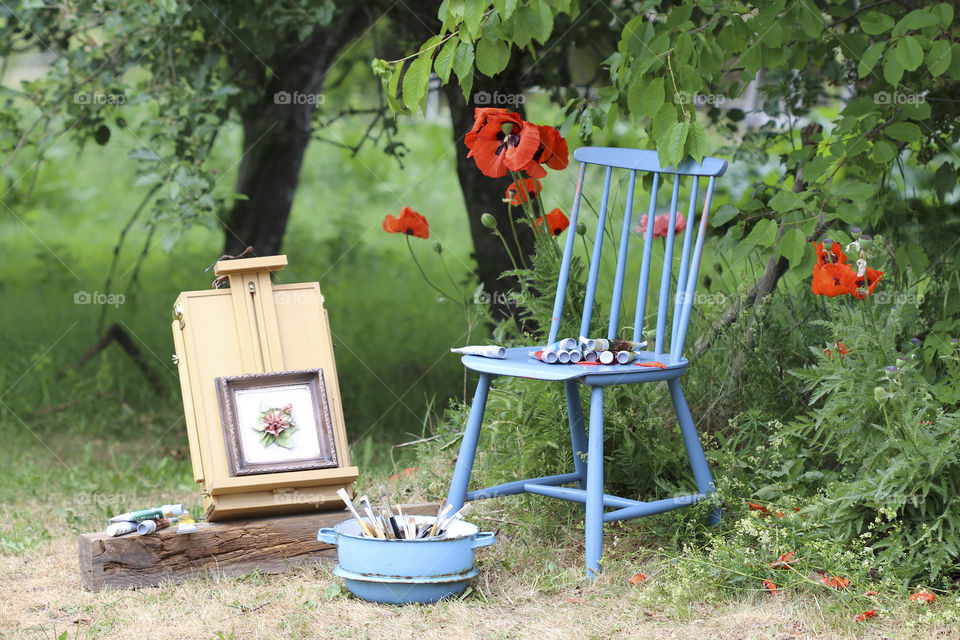 red poppy, blue chair and painted painting