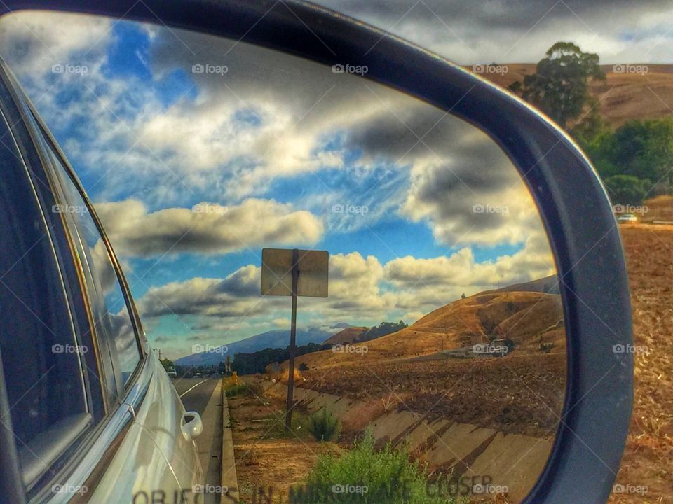 Side mirror view . Side mirror view of the clouds 
