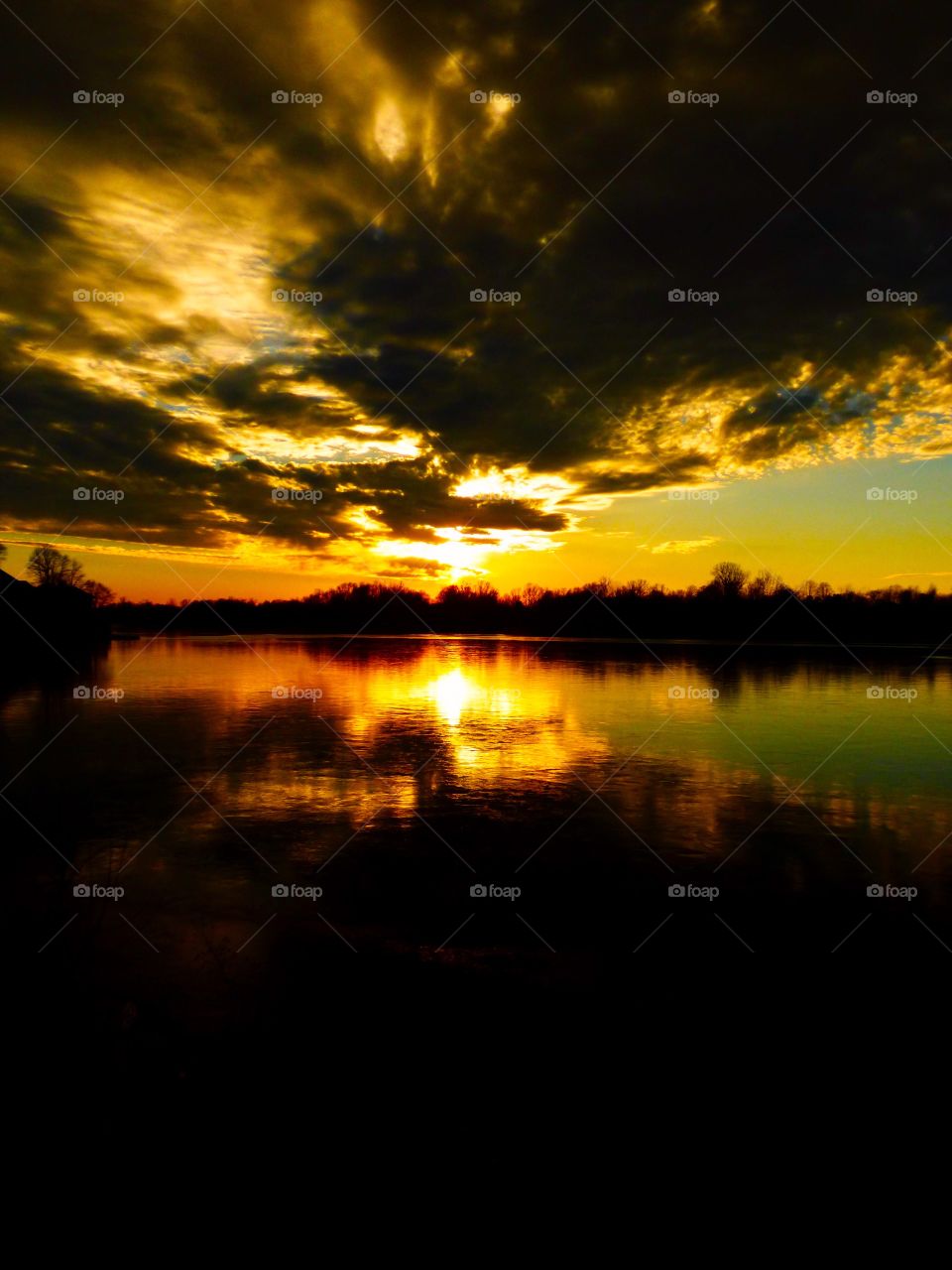 Reflection of sky cloud on lake during sunset