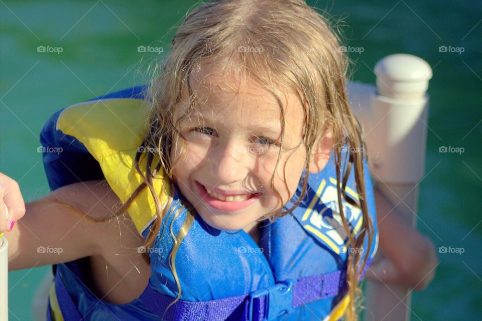 Wet girl wearing life jacket