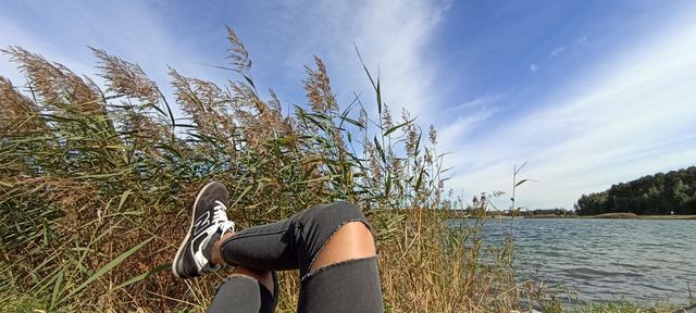 woman meditation female legs blue sky clouds outside