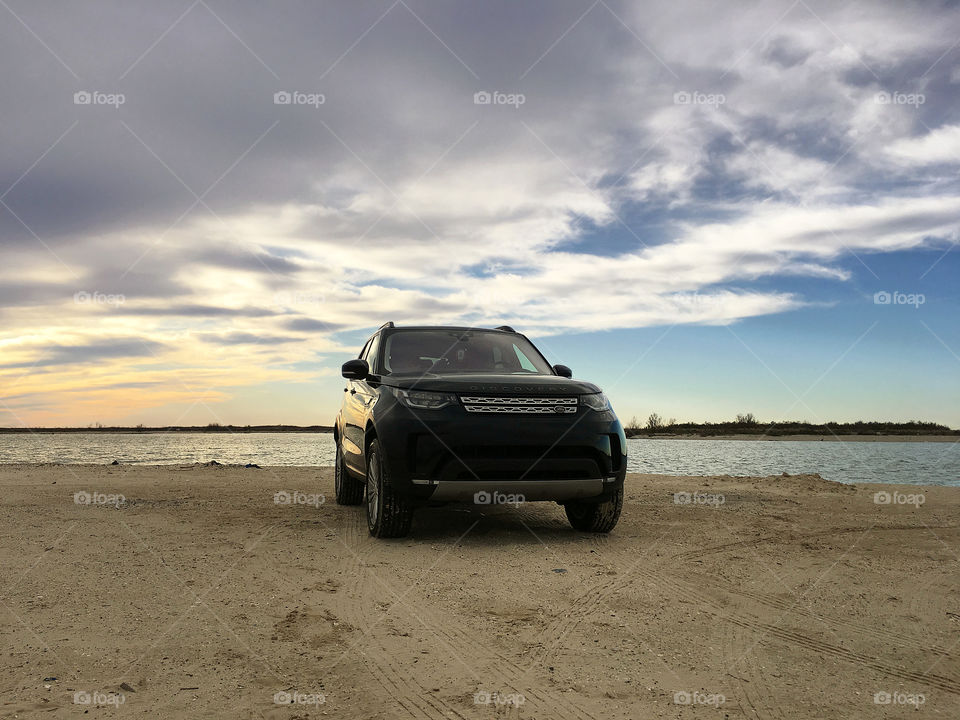 Black 2017 land rover discovery hse driving on beach sand, luxury suv, jetty park, matagorda, texas