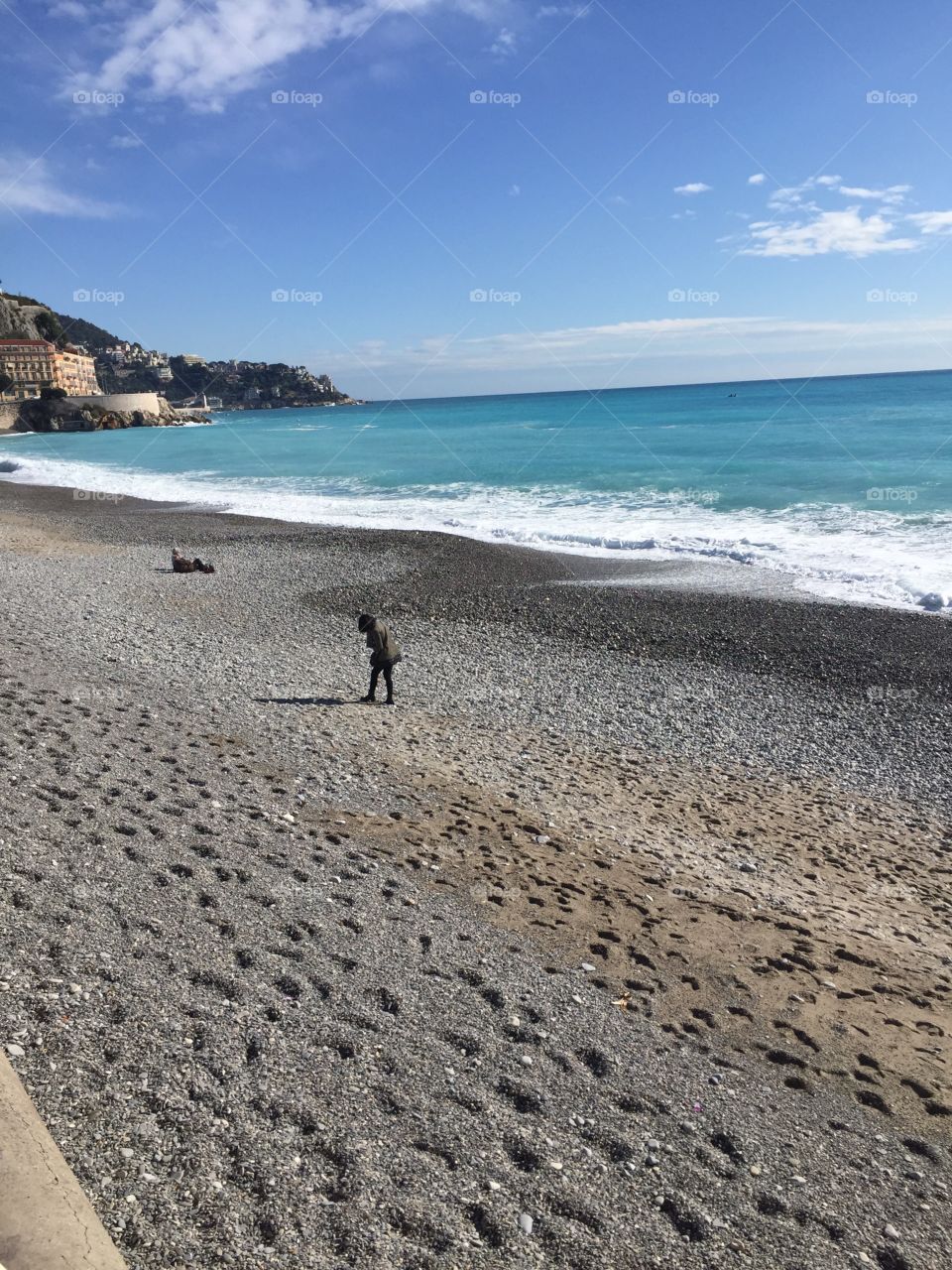 Person walking on sandy beach