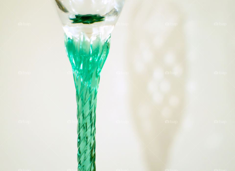 Vintage Green crystal champagne glass stem closeup isolated on white background 