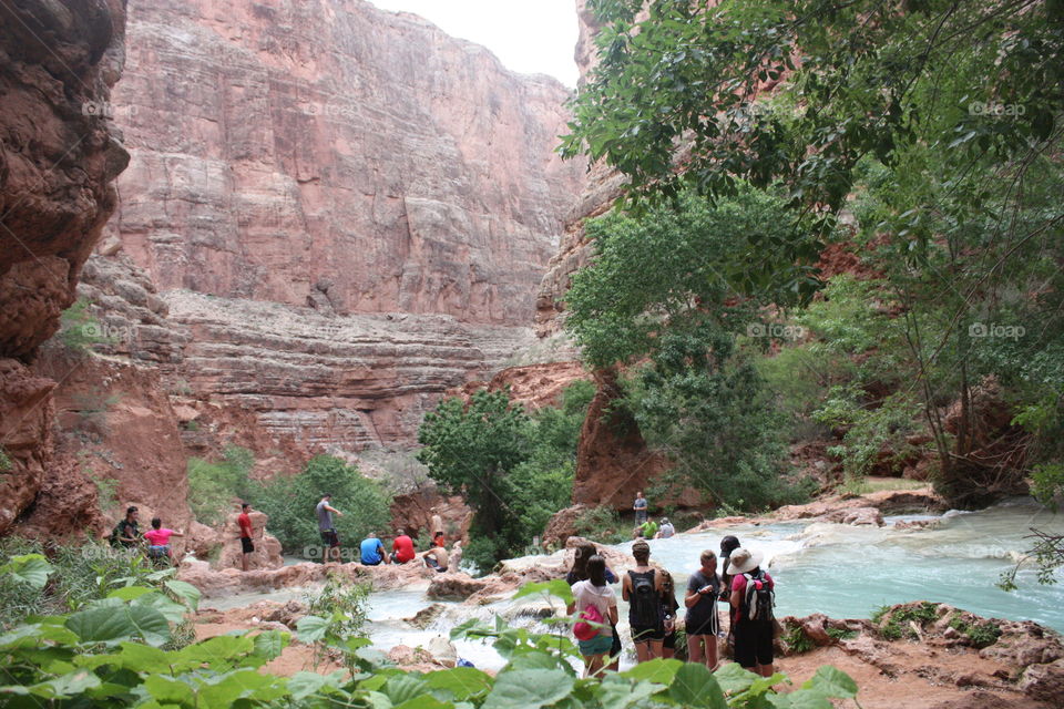 People admiring and exploring the beautiful Colorado River that runs through the Grand Canyon