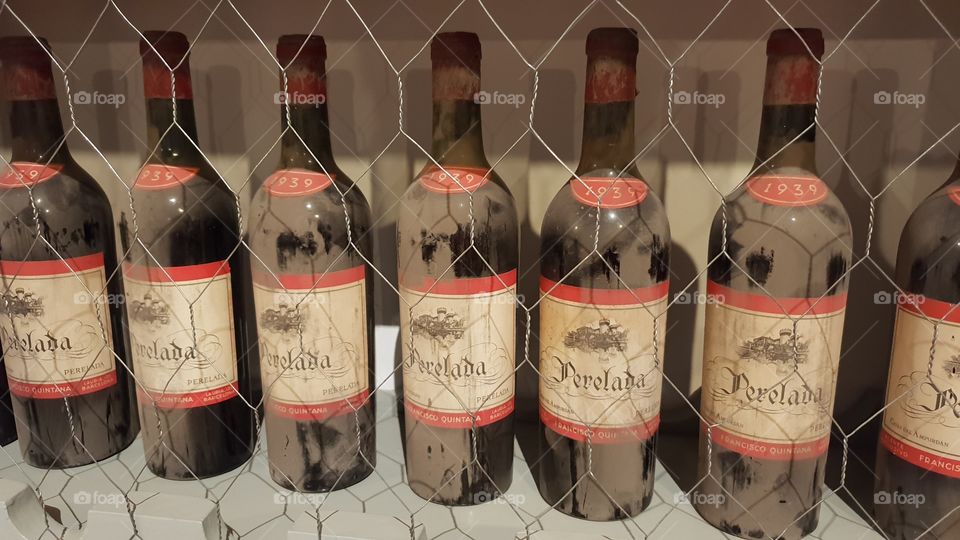 Old, dusty wine bottles within the Royal Palace of Madrid's kitchen.