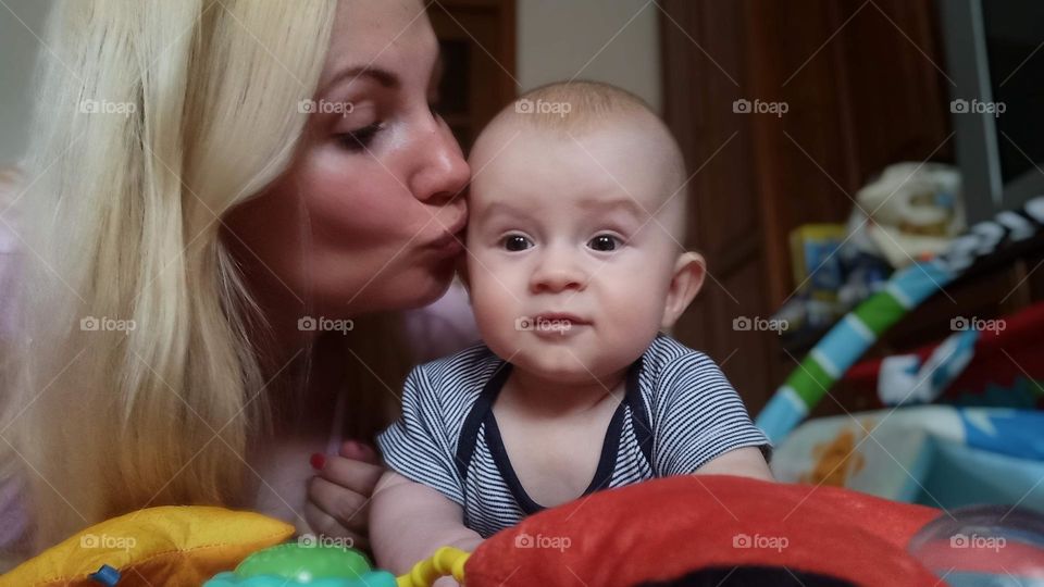 mother kissing her baby