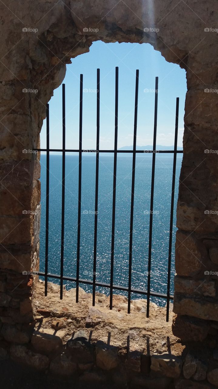 Idyllic sea seen through arch window