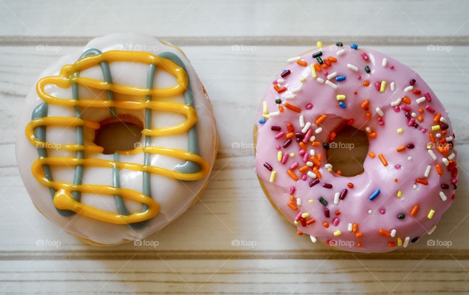 Two Donuts Brightly Colored On A Wooden Table, Food Photography 