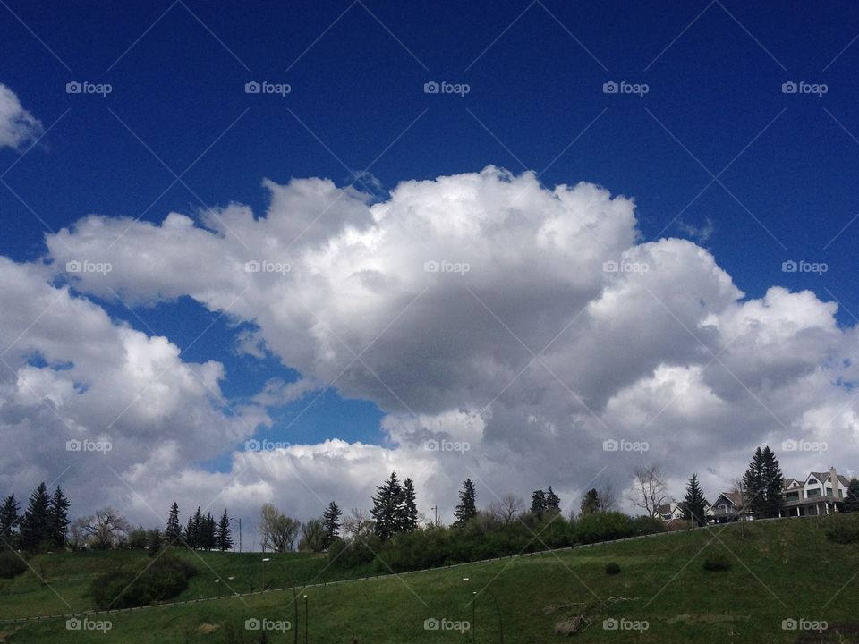 big fluffy white clouds floating in a bright blue sky